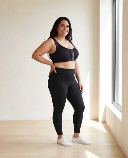 A woman in her late thirties in the black bra and black leggings