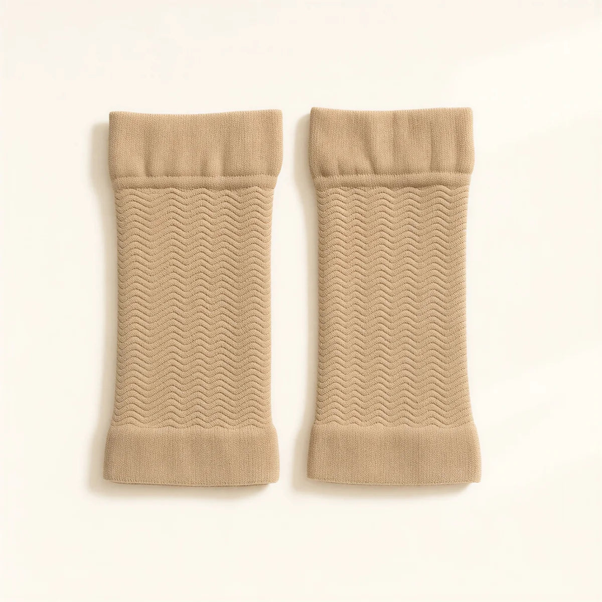 A pair of beige arm sleeves, flat