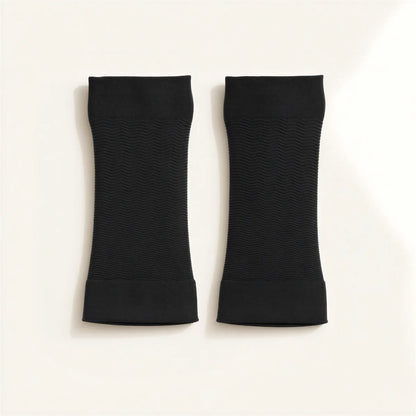 A pair of black arm sleeves, flat